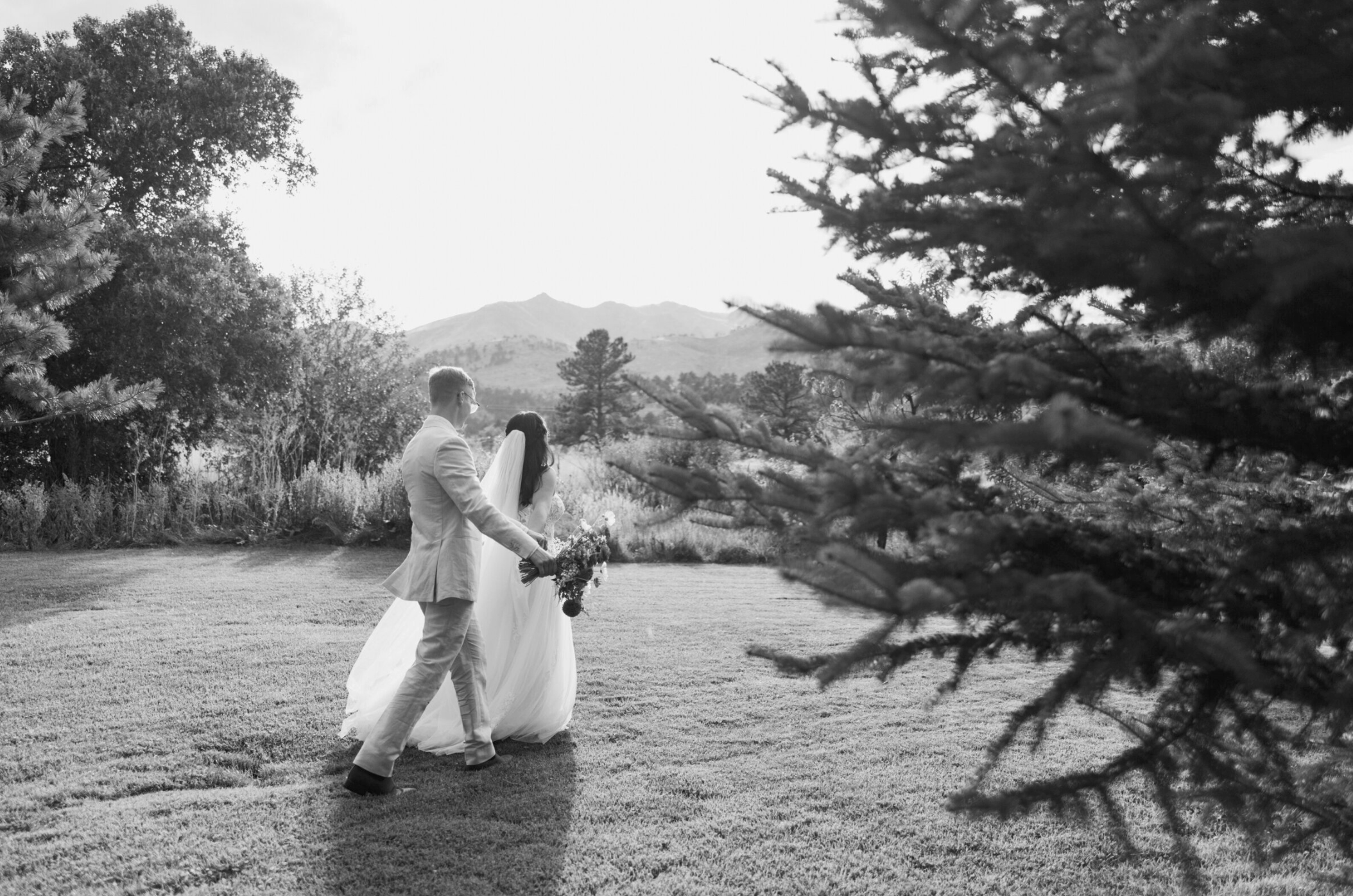 Wedding at greenbriar inn in boulder Colorado, couple walking in front of mountains